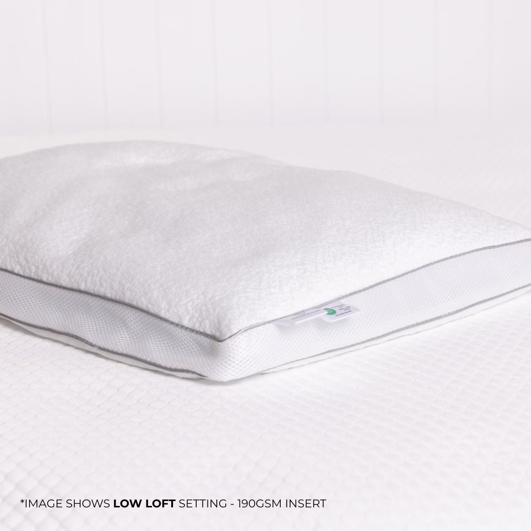White pillow with a visible brand logo on a white background