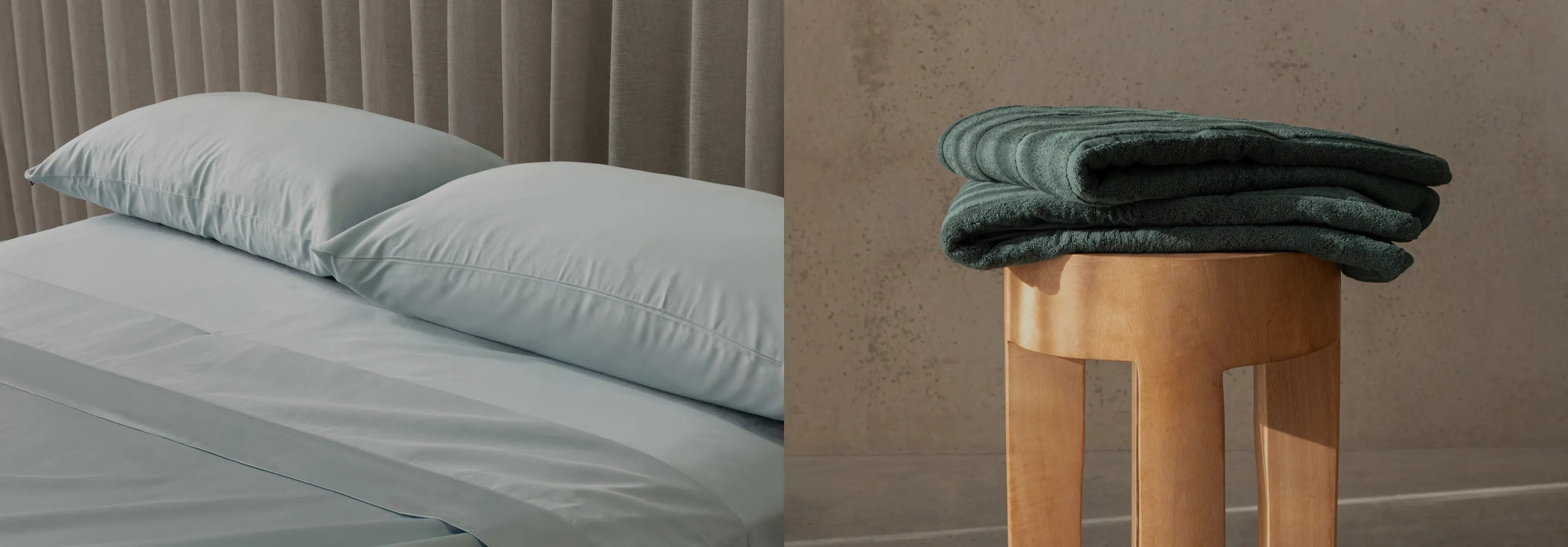 Teal bedding set on a bed and folded teal towel on a wooden stool against a beige wall.