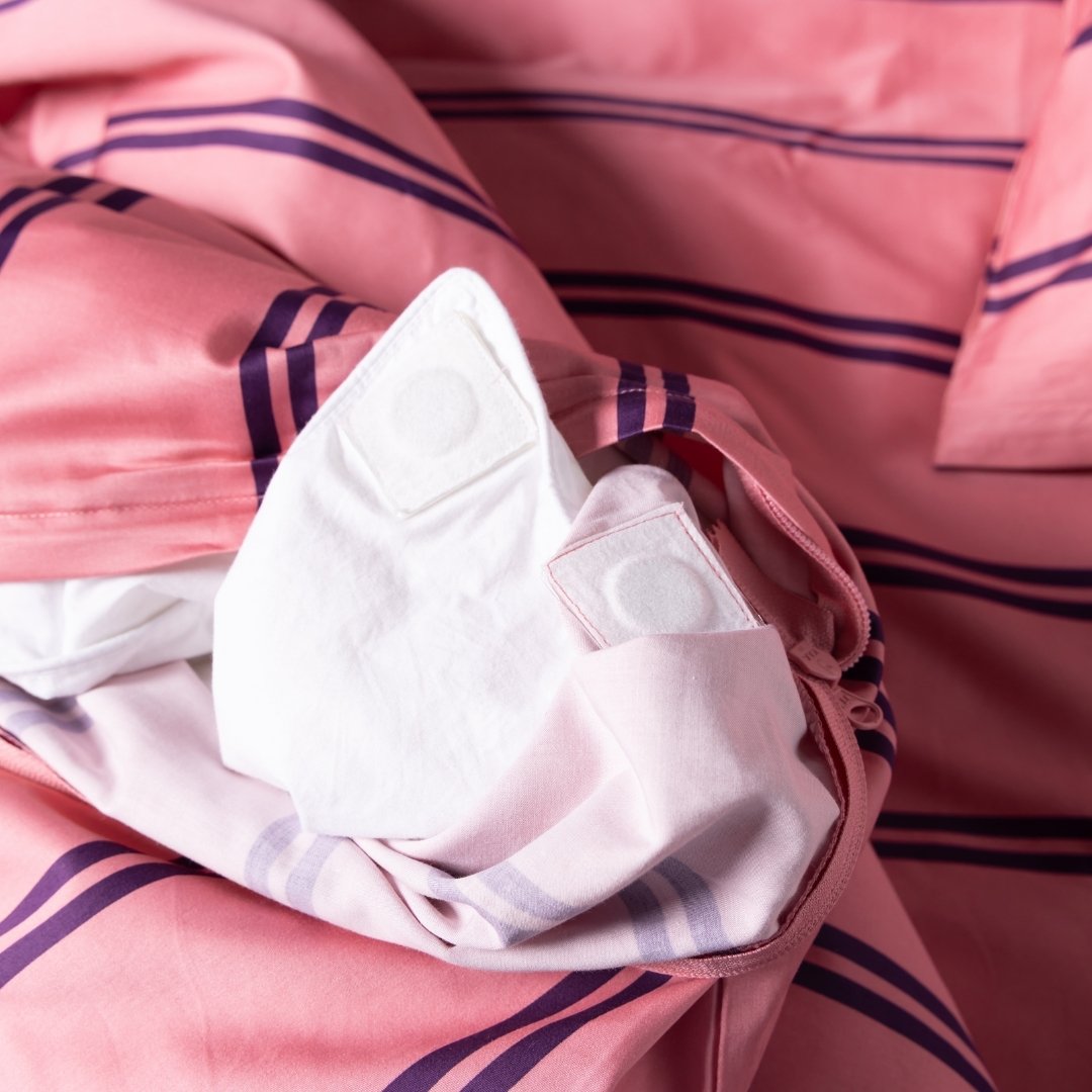 Close-up of pink fabric purple stripes, showcasing the quilt covers magnetic corners.