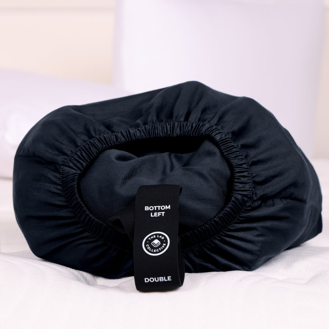 Black Joey Pouch with fitted sheet stuffed inside.