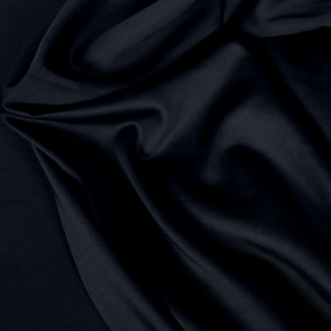 Close-up of dark black fabric with folds.
