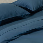 Blue bedding set with two pillows on a bed