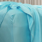 Close-up of light blue bedding with a neutral background