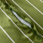 Close-up of a green quilt cover with a zipper on a green background.
