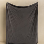 Charcoal coloured cooling blanket held up.