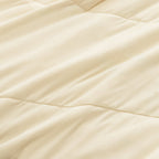 Close up of fabric texture on the beige / cream coloured cooling blanket.