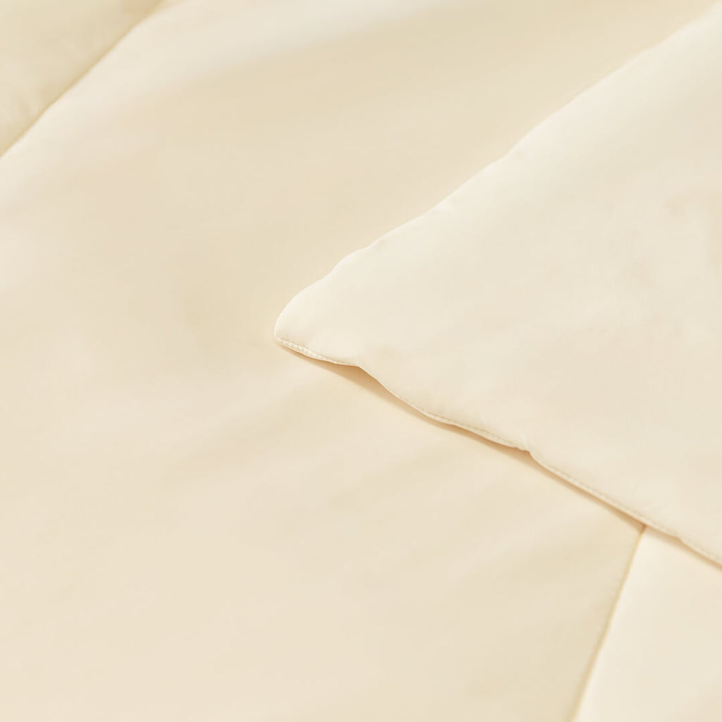 Close up of corner and stitching on the beige / cream coloured cooling blanket.