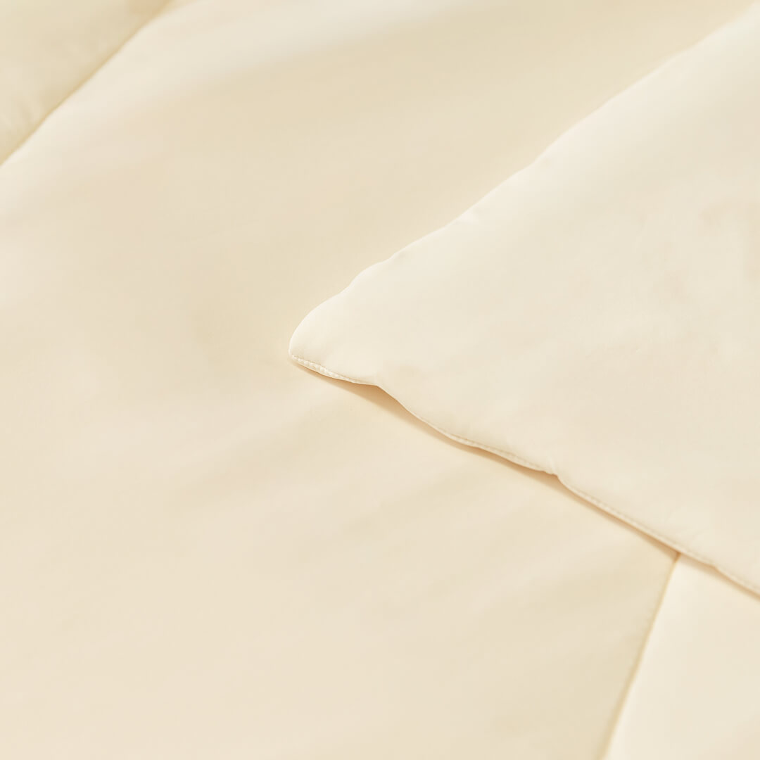 Close up of corner and stitching on the beige / cream coloured cooling blanket.