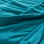 Teal coloured cooling blanket close up of fabric texture.