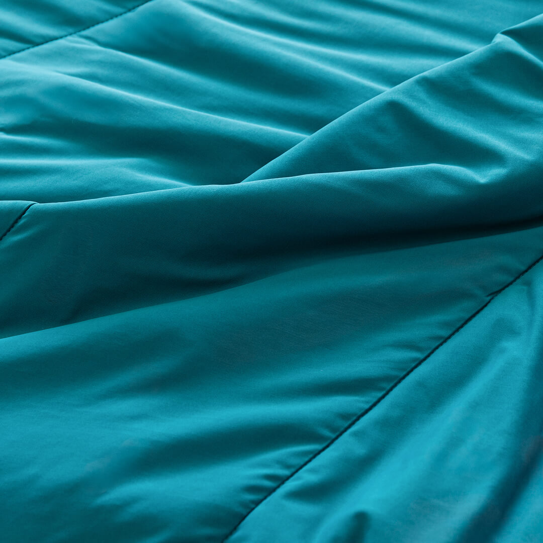 Teal coloured cooling blanket close up of fabric texture.