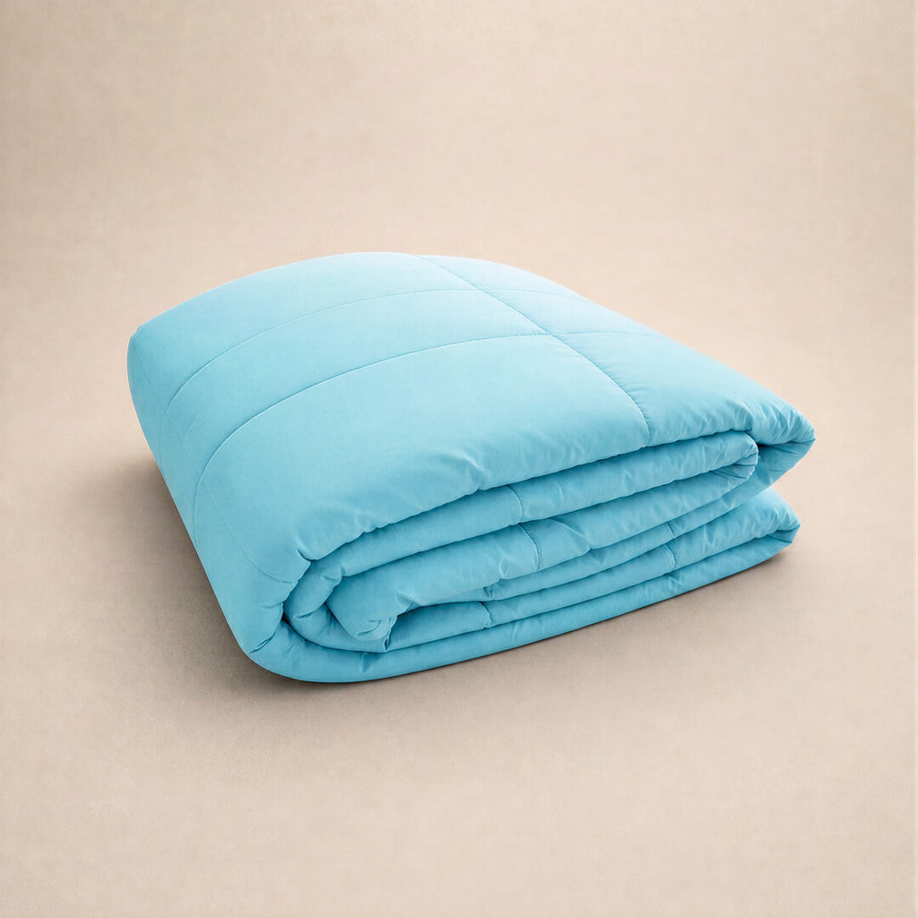 Light bright blue cooling blanket folded.