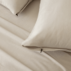 Close-up of beige pillowcases with concealed zipper closures, showcasing the secure fastening detail and soft textured fabric.