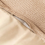 Close-up of a textured beige fabric with a zipper.