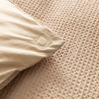 Close-up of a textured beige quilt cover magnetic corner.