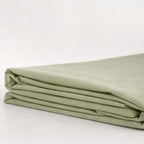 Folded green fabric on a white background.