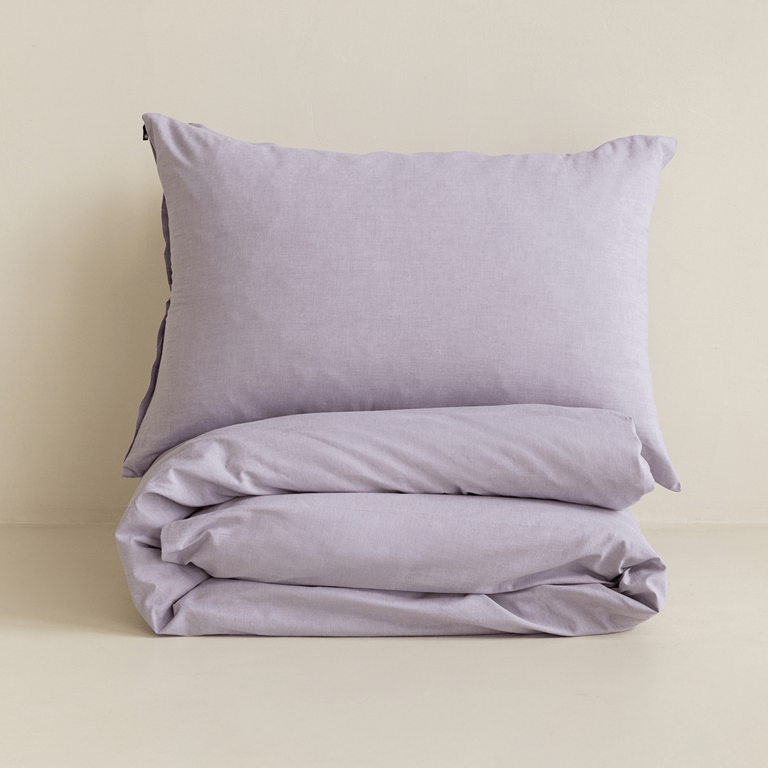 Folded Daylesford lilac quilt cover set with matching pillowcase displayed for product presentation.