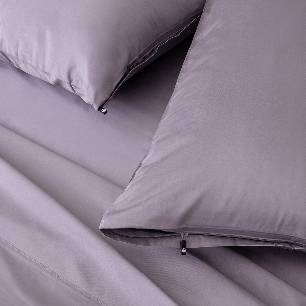 Close-up of the Daylesford bedding featuring matching lavender pillowcases with concealed zipper closures and smooth, silky sheets.