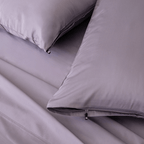 Close-up of the Daylesford bedding featuring matching lavender pillowcases with concealed zipper closures and smooth, silky sheets.