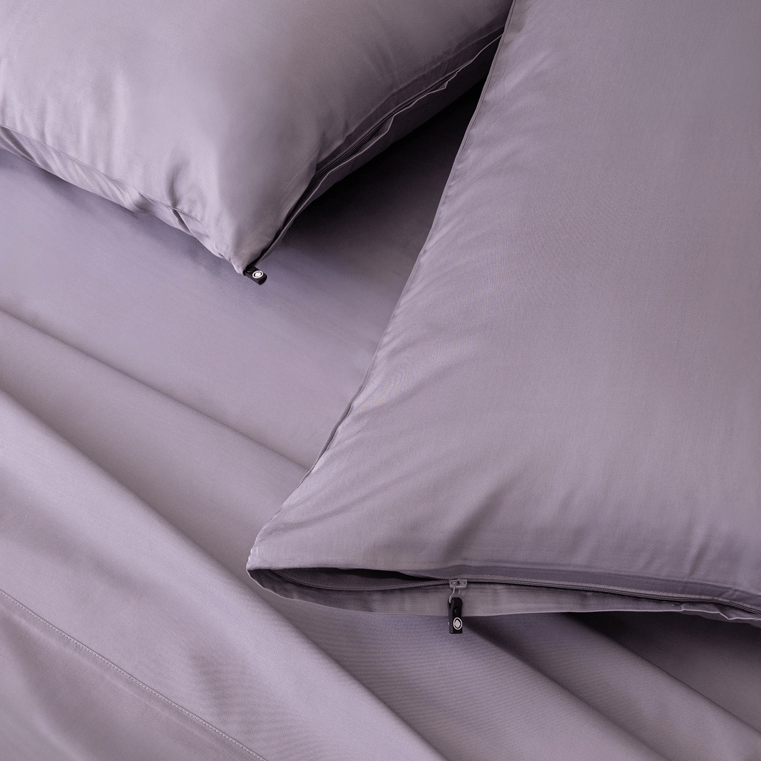 Close-up of the Daylesford bedding featuring matching lavender pillowcases with concealed zipper closures and smooth, silky sheets.