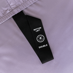 Close-up of the fitted sheet's labeled corner strap marked "Bottom Left" for quick and easy bed-making.