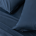 Close-up detail of navy blue pillowcases featuring hidden zipper closures