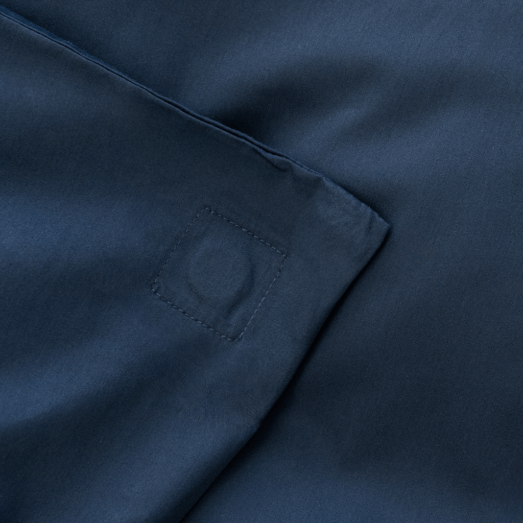 Close-up corner view of navy blue fabric showing square-stitched corner reinforcement detail
