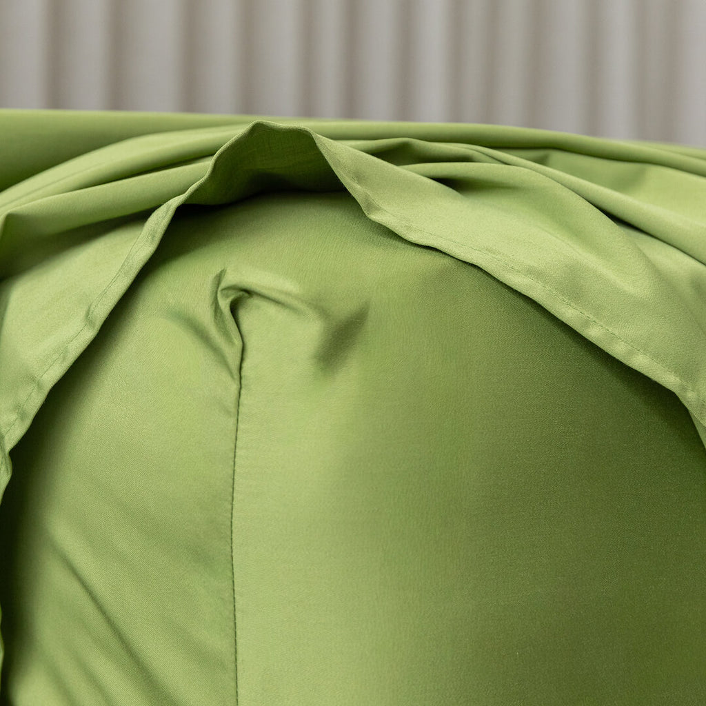 Close-up of green bedding with a neutral background.