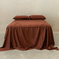 Chocolate brown bedding set on bed.