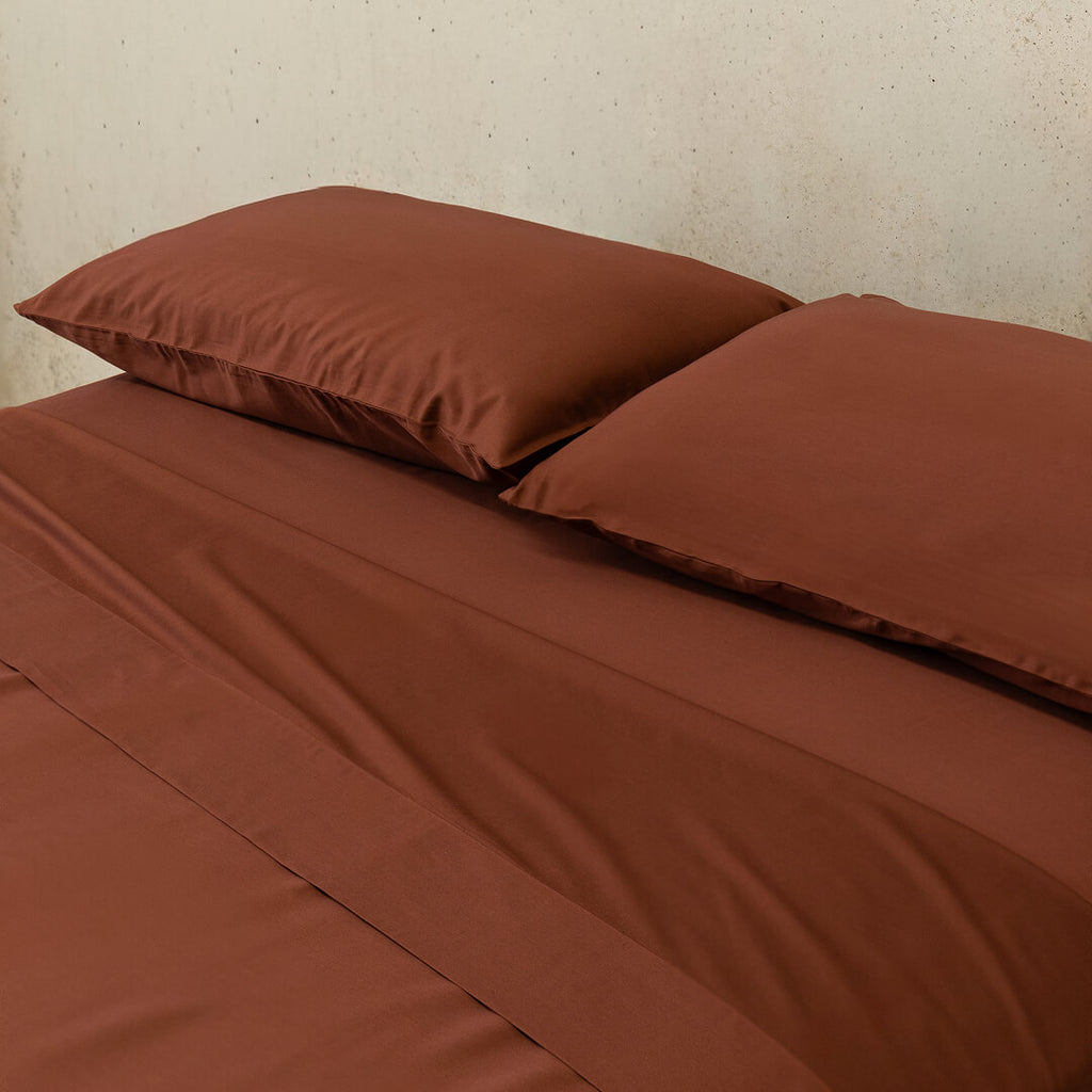 Chocolate brown bedding set on bed.