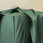 Corner close up of green fitted sheet.