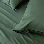 Dark green invisible zip pillowcases on the bed.