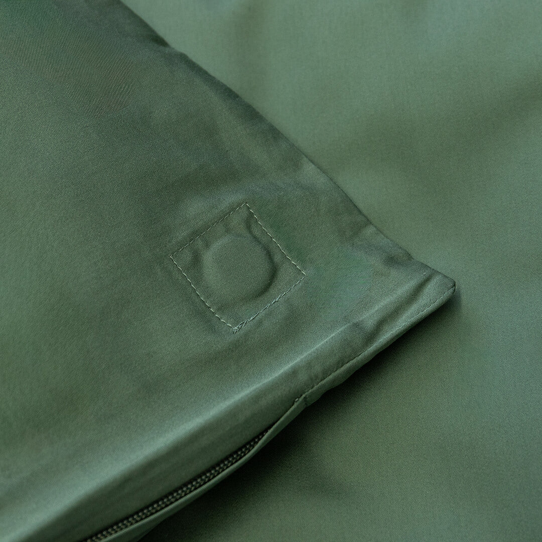 Close-up of green fabric with a corner magnet.