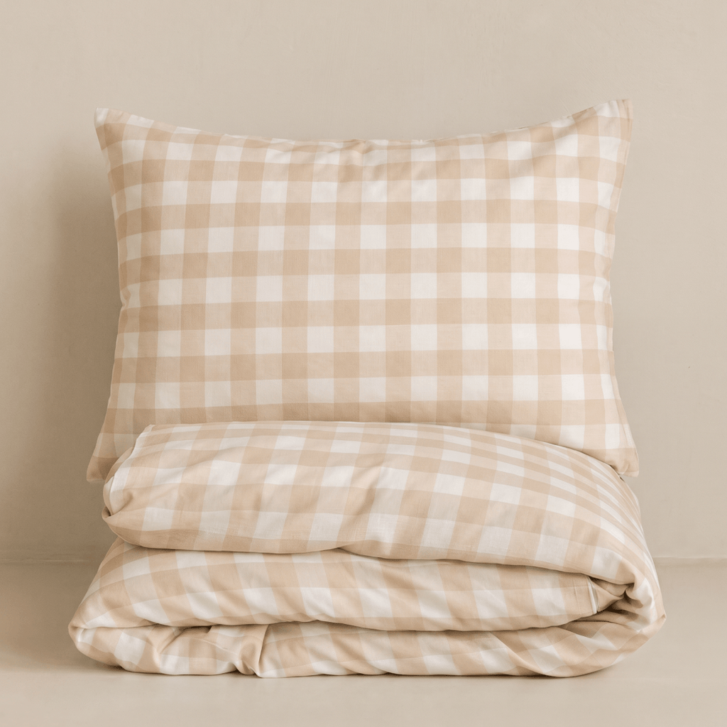 Folded beige gingham quilt cover set with a matching pillowcase, showcasing the classic checkered pattern, soft fabric, and coordinated neutral design.