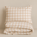 Folded beige gingham quilt cover set with a matching pillowcase, showcasing the classic checkered pattern, soft fabric, and coordinated neutral design.