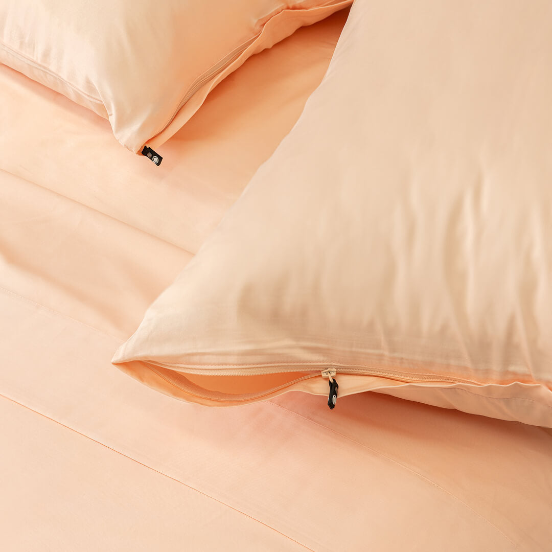 Close-up of peach-colored pillows on a matching fabric background