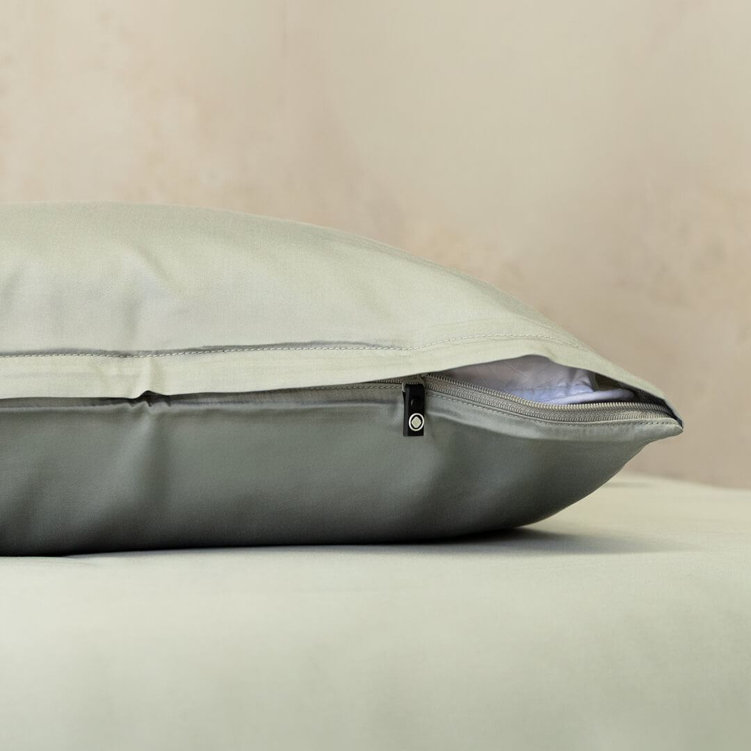 Gray pillow with zipper on a beige background