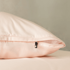 Close-up of a blush pink pillowcase featuring a concealed zipper closure, highlighting the secure fastening detail and soft, elegant fabric finish.