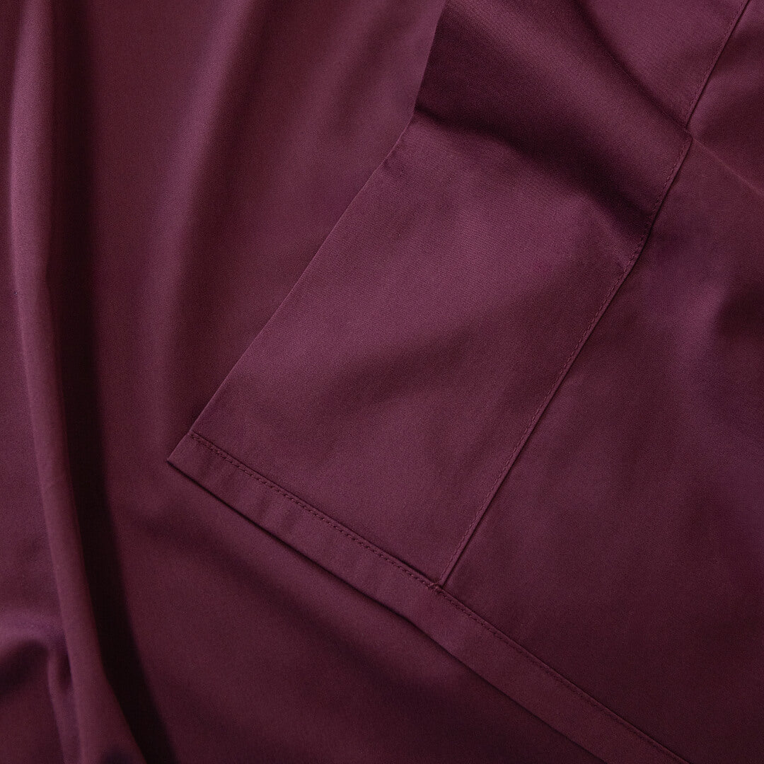 Close-up of a burgundy fabric folded over itself.