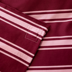 Close-up of the striped quilt cover corner, highlighting the stitched loop detail and finished seams.