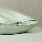 Detailed view of a sage green pillowcase with concealed zipper closure, showcasing the smooth fabric finish and premium construction.