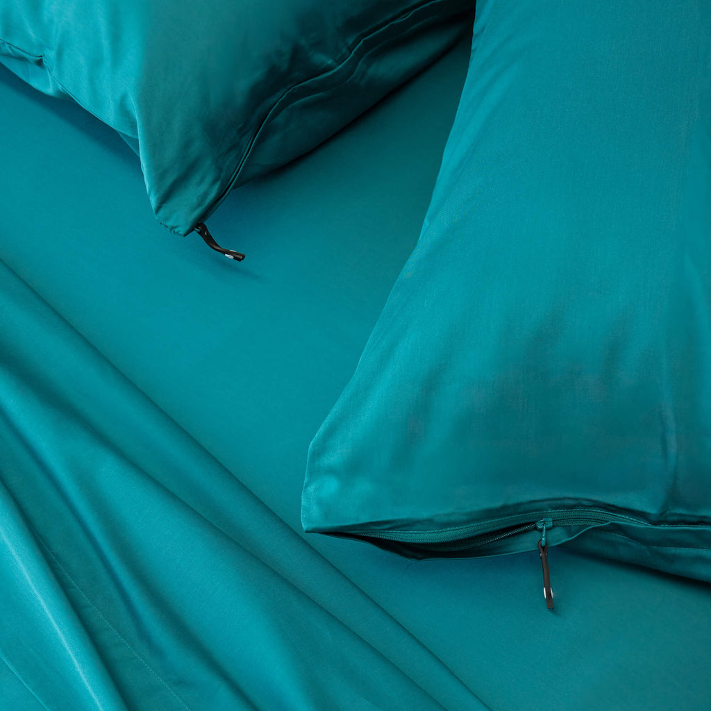 Pair of 2 pillowcases in teal green colour, close up of zip
