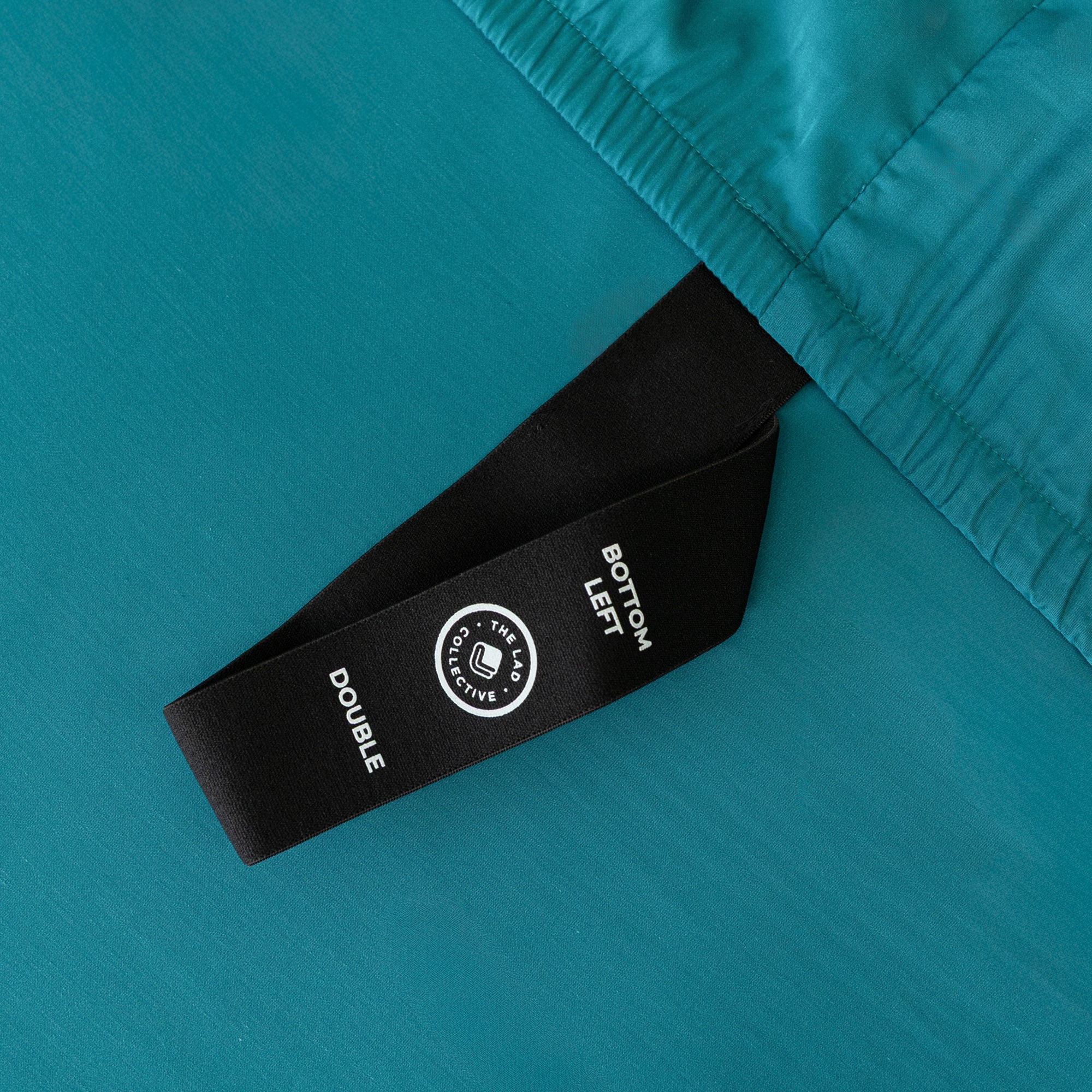 Close up of corner strap in Teal Bedding