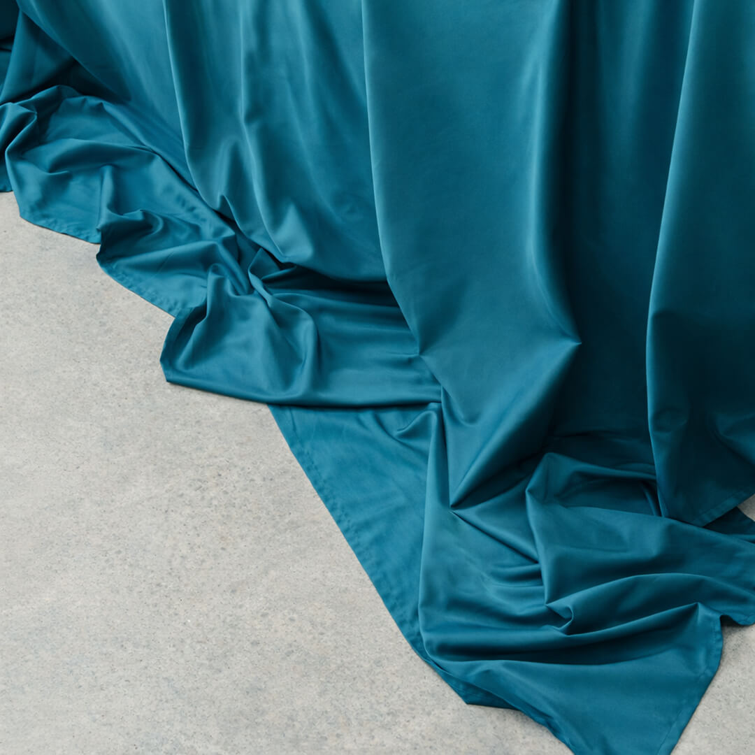 Teal fabric draped over a surface