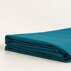 Folded teal fabric on a white background.