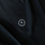 Black fabric with a white logo in the center.