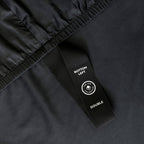 Close up of corner strap detail in dark charcoal fitted bed sheet