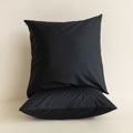Black pillow on a beige background