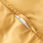 Close-up detail of a golden yellow quilt cover featuring a dual zipper closure