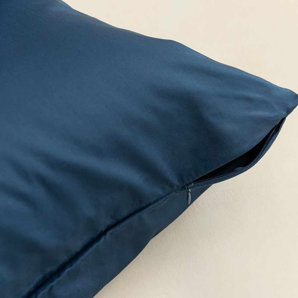 Blue pillow on a beige background, showcasing invisible zip.