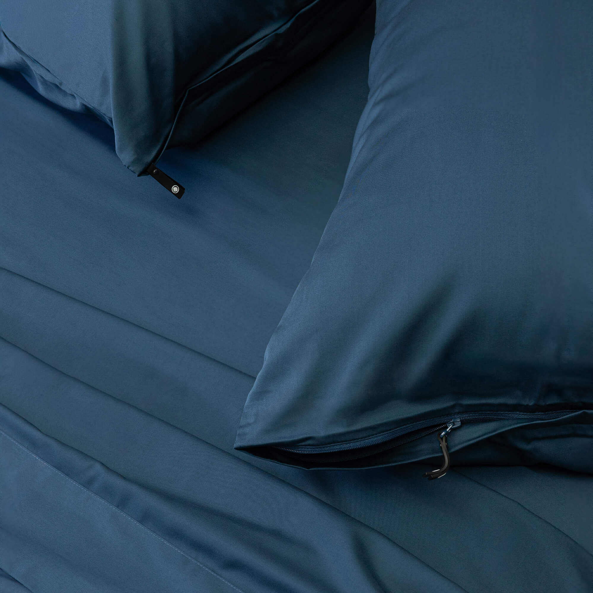 Blue bedding set with pillows on a bed
